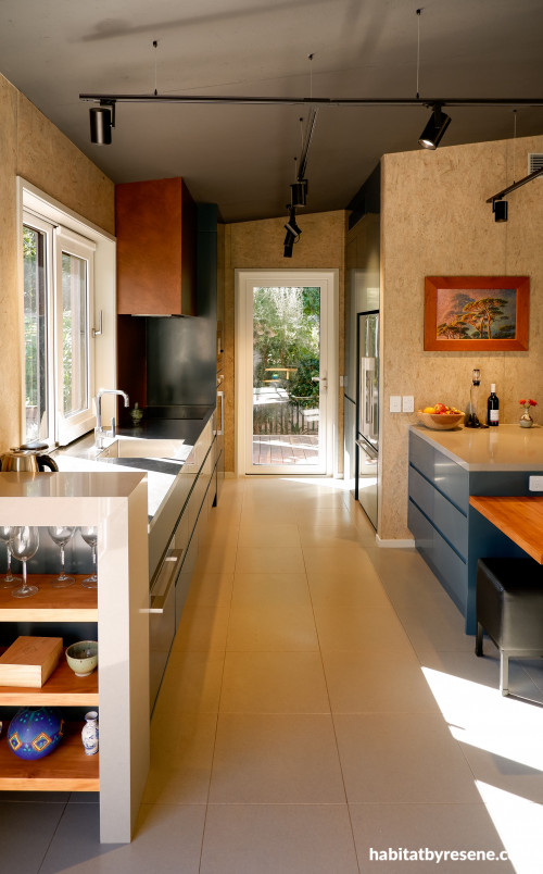 Kitchen offers contrasting dark tone cabinetry and light tone natural wood