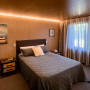 Bedroom exudes cosiness in its warm and dark tones