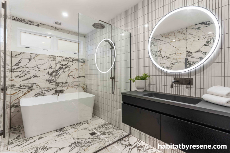 Any bathroom style seamlessly blends with Resene Eighth Black White, used in this bathroom on the ceiling and trims to complement the neutral shaded marble and finger tiles.