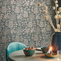 Dark floral wallpaper fits just right into small dining space