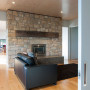 living room, lounge, white lounge, stone feature wall, fireplace, grey door 