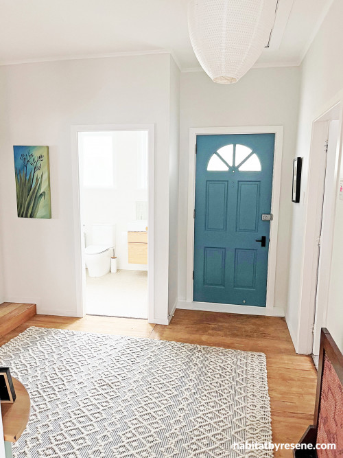 Blue door in white hallway