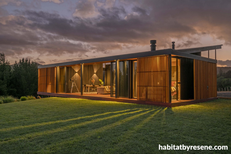 Modern home with warm lights and backyard