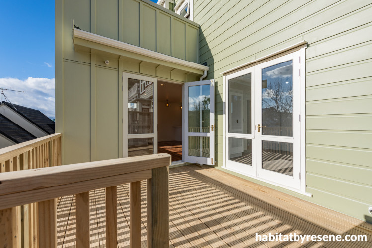 Home with green weatherboard and double opening doors