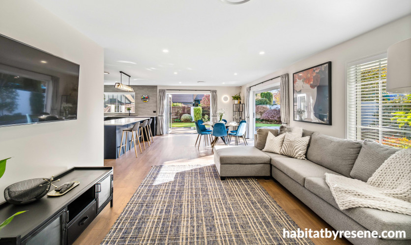 The large open plan living, kitchen and dining, hallways, and entry are painted in Resene Merino with Resene Black White on all ceilings, doors and trims