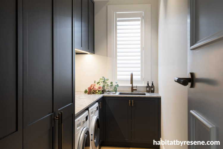 The laundry is a dreamy space that reflects the home’s colour palette, with Resene Double Tuna on cabinetry and Resene Half Sea Fog on walls and trims. 