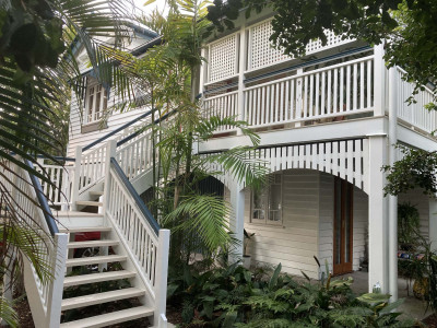 This century-old Brisbane Queenslander is transformed into a tropical oasis with summer green Resene Edgewater and Resene Warrior