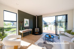 Resene Half Merino on walls and Resene Quarter Merino on the ceiling were used to balance the deep forest green of Resene Half Karaka in the living room, creating a bright, refreshing and open feel.