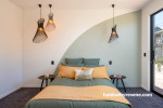 A gentle green hue was used as an alluring statement in the master bedroom