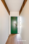 This nature inspired entryway features cedar slats at the top of the walls