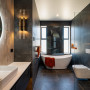 The main bathroom features dark stone toned slate