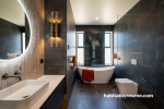 The main bathroom features dark stone toned slate