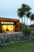 Auckland eco home built from recycled power poles is splashed with vibrant Resene yellows and rocky coast greys