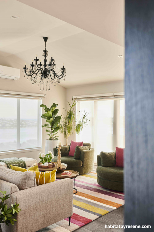 The warm and dusky shade of Resene Double White Pointer coats the walls in this stylish and colourfully accented living space.