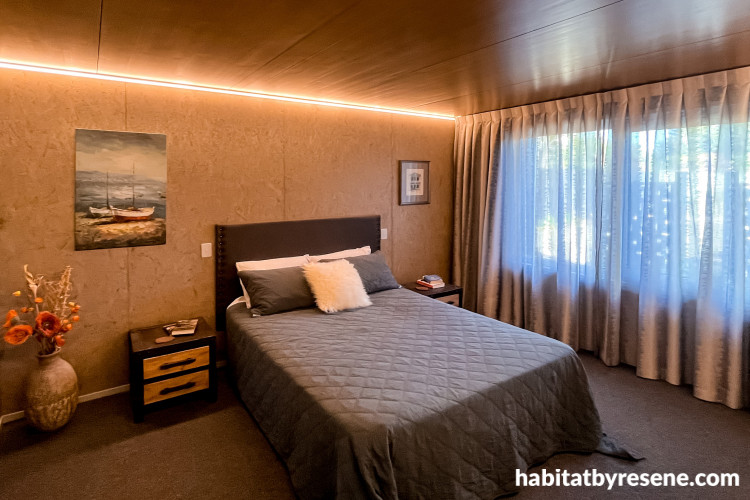 Bedroom exudes cosiness in its warm and dark tones