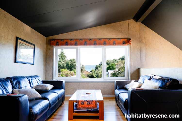 Lounge with light natural tone walls and dark grey ceiling