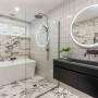 Any bathroom style seamlessly blends with Resene Eighth Black White, used in this bathroom on the ceiling and trims to complement the neutral shaded marble and finger tiles.