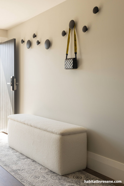 A shade that is both cosy and bright, Resene Double Merino, welcomes guests at the entrance. Ceiling and trims are painted in Resene Quarter Bianca.