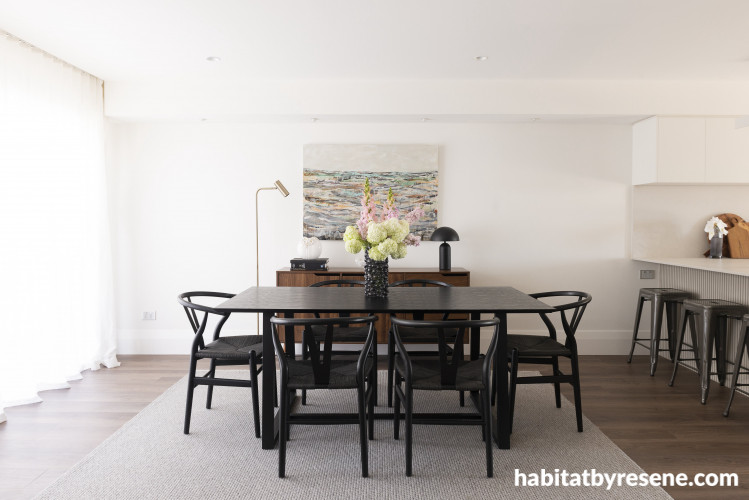 Timeless neutrals bring this dining room to life, brightening the space and creating a stunning contrast to the flooring and dark furniture.