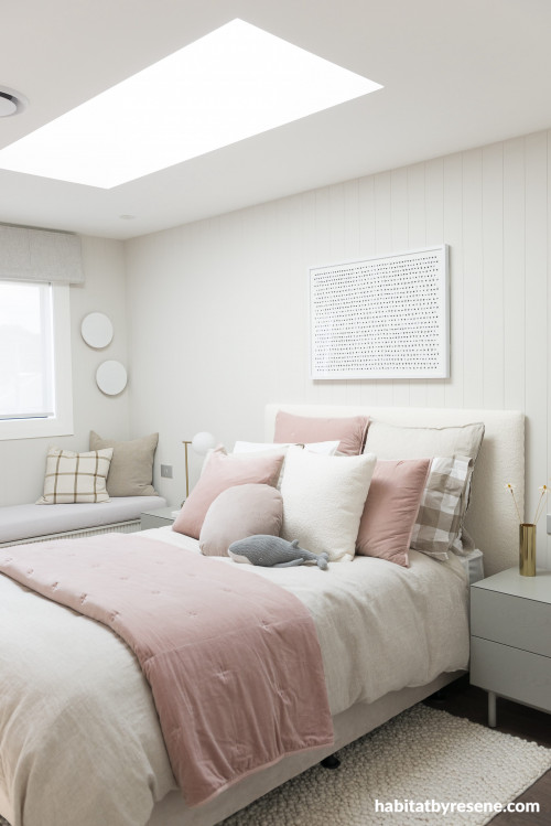 The subtle flamingo design on the opposite wall contrasts joyfully with the tongue-and-groove panelling painted in Resene Quarter Truffle. Ceiling in Resene Quarter Bianca.