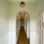 The hallway walls are painted in Resene Merino, with lower panelling and ceiling in Resene Alabaster. The front door is in Resene Blanched Pink.