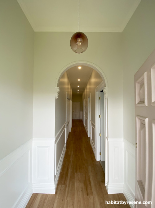 The hallway walls are painted in Resene Merino, with lower panelling and ceiling in Resene Alabaster. The front door is in Resene Blanched Pink.