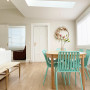 Pops of greens and pinks flow through the open plan living and dining in décor. The walls are painted in Resene Merino. 