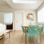 Pops of greens and pinks flow through the open plan living and dining in décor. The walls are painted in Resene Merino.