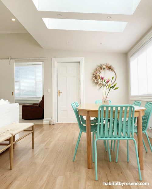Pops of greens and pinks flow through the open plan living and dining in décor. The walls are painted in Resene Merino.