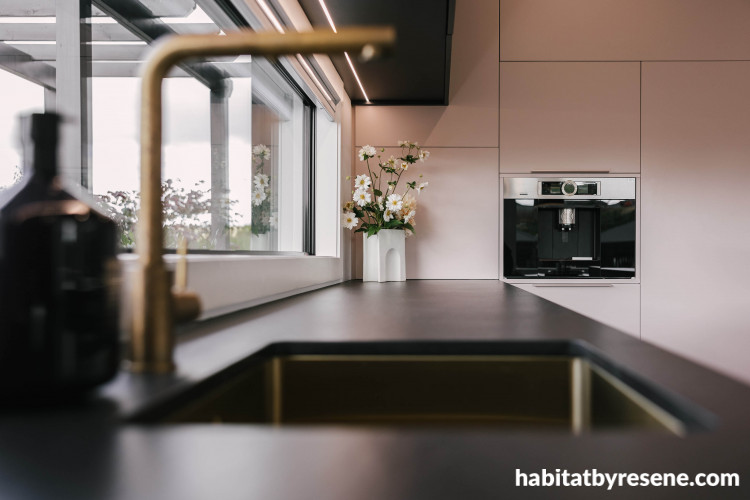 Dusty amber toned pink brings a sense of serenity to this kitchen