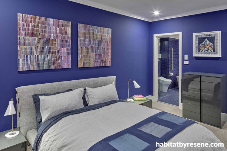 Bedroom with purple walls and white trims creates vibrant atmosphere 