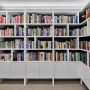 Home library painted in white creates sophisticate space.