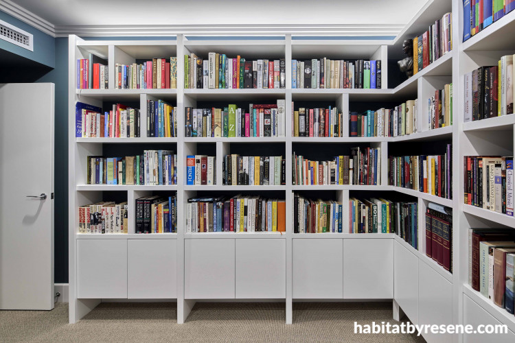 Home library painted in white creates sophisticate space.