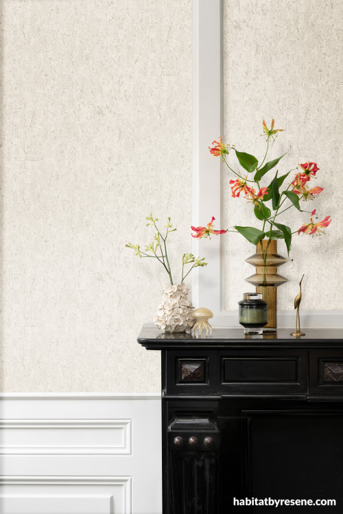 Living area featuring featuring neutral textured wallpaper