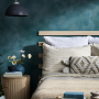 Teal bedroom featuring wall painted in Resene Undercover with Resene FX Paint Effects Medium mixed with Deep Teal and Nepal