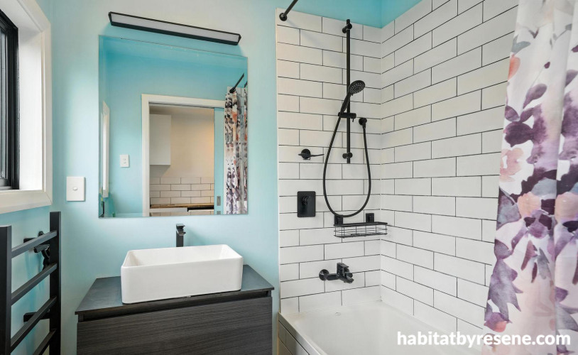 Bathroom featuring white tiles and sky blue walls