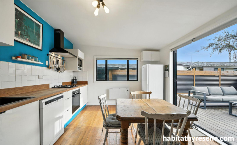 Kitchen with white walls and blue feature wall