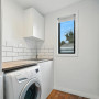 White laundry with a light blue door and back wall