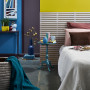 Bedroom featuring bright yellow and blue walls