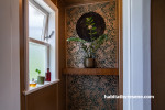 Corner window and walls featuring Resene metallic and teal floral wallpaper