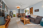 Living room featuring soft blue walls and a bold green front door