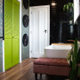 Bathroom featuring moody black tiles, Resene wallpaper and vivid green doors