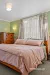 Bedroom featuring soft green walls