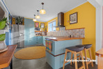 Kitchen featuring bright yellow walls and soft blue cabinets