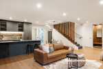 Open plan kitchen and living area featuring white walls in Resene Rice Cake