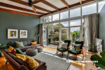 Mid-century inspired living room featuring dark green Resene Jurassic