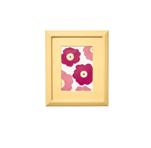 A painting of flowers in a yellow frame