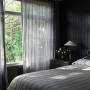 Bedroom featuring walls and ceiling painted in striking black Resene Element