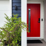 Dark blue house exterior with bright red front door