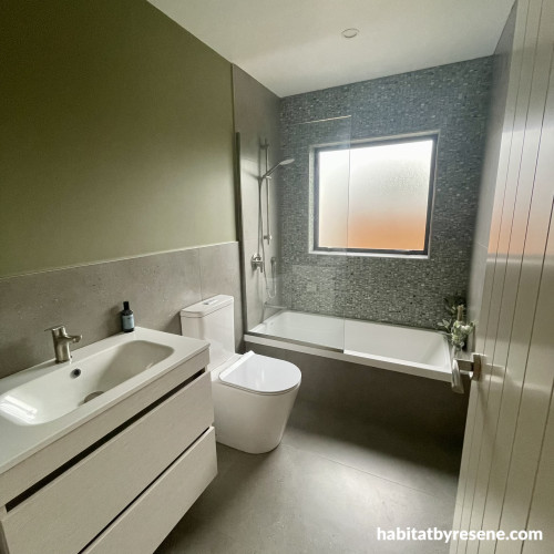 Family bathroom in Resene Bitter, door in Fossil and ceiling in Alabaster. 